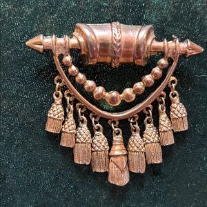 Gold tone brooch with dangles